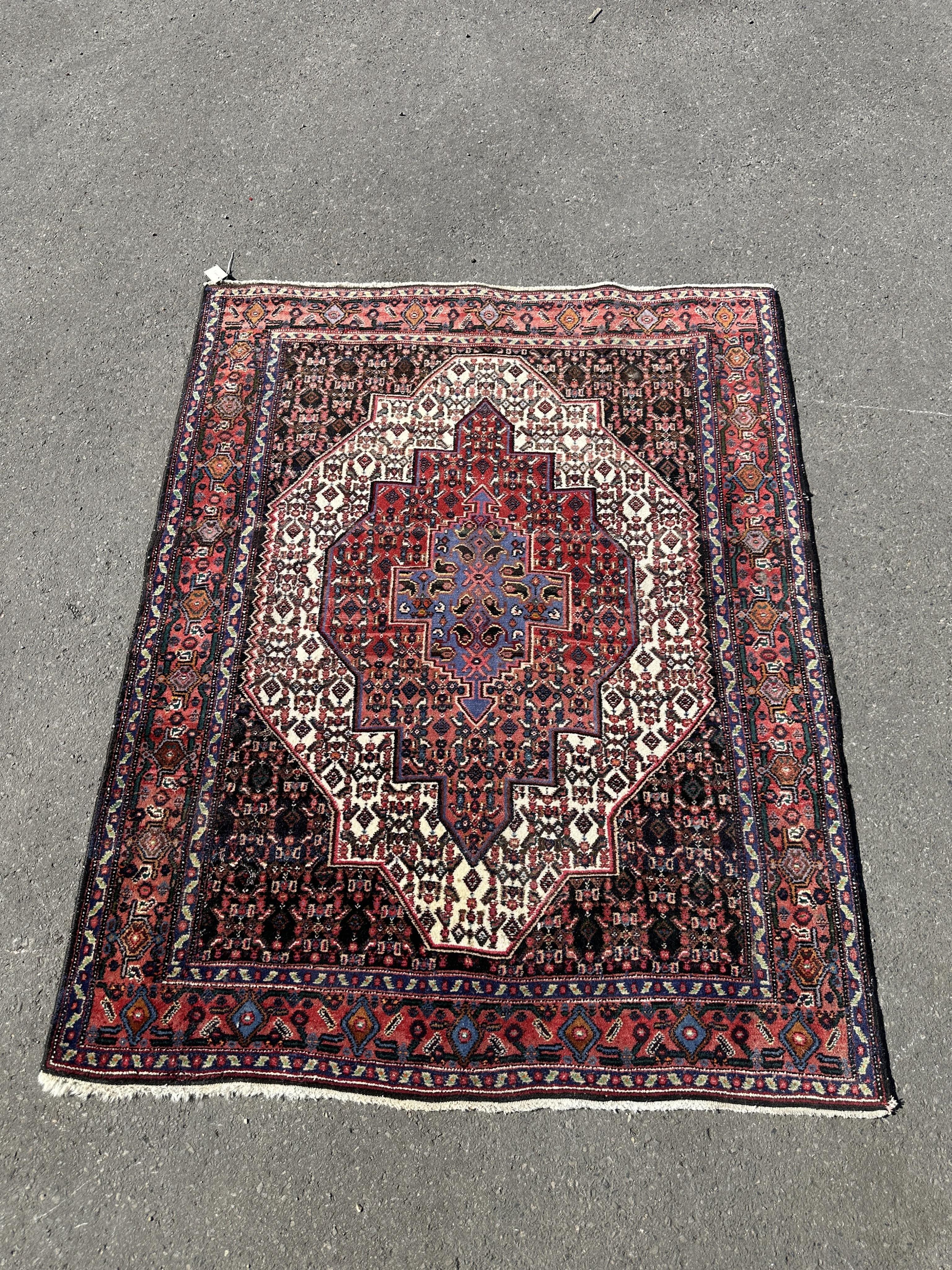 A North West Persian ivory ground rug, 158 x 126cm